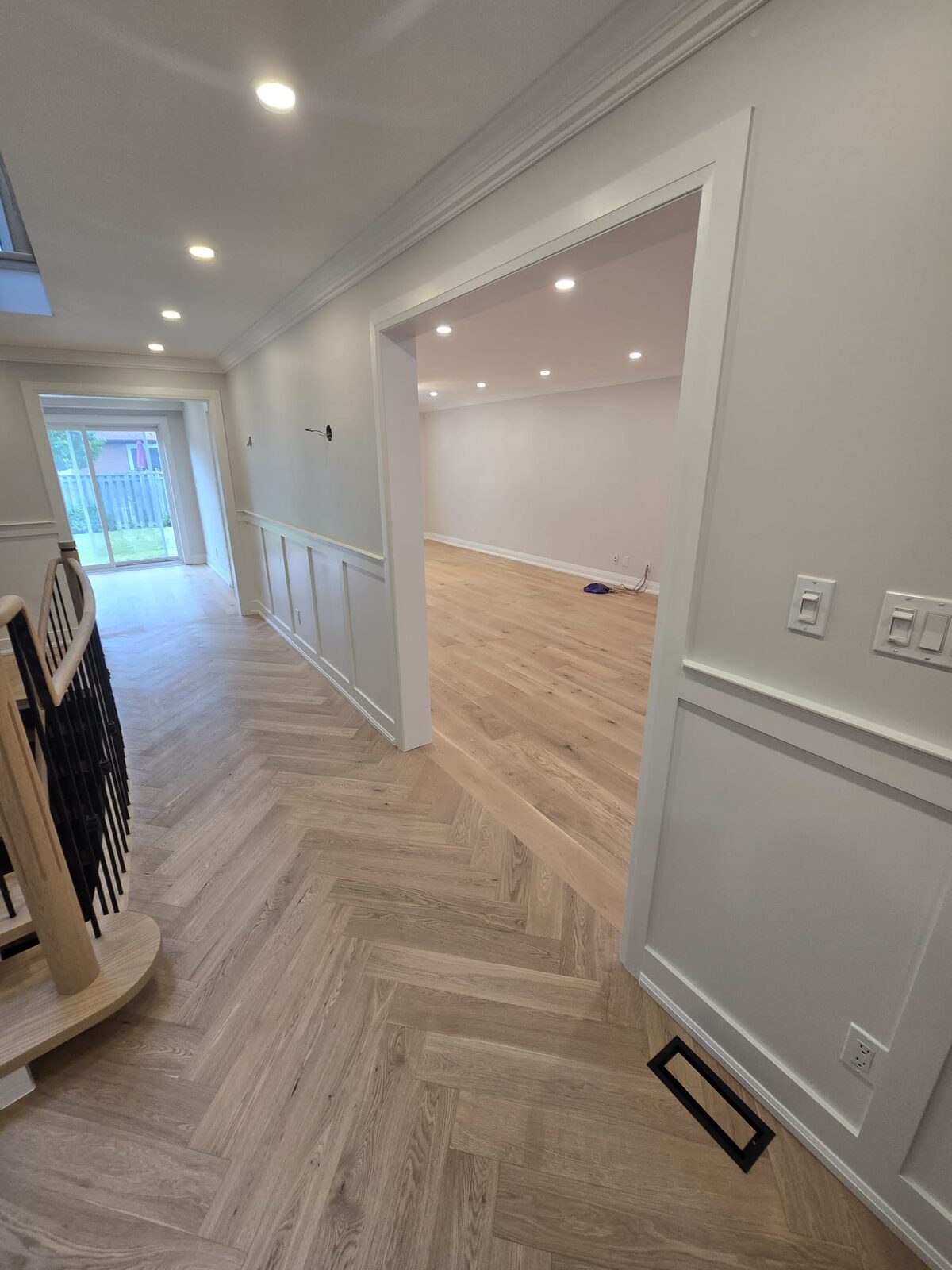 Herringbone hardwood flooring installed through a hallway by ARK Renovation