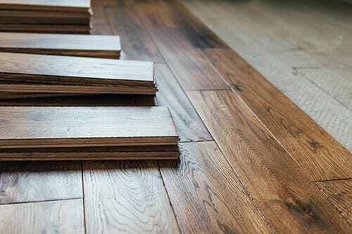 Close-up of hardwood flooring mid-installation by ARK Renovation
