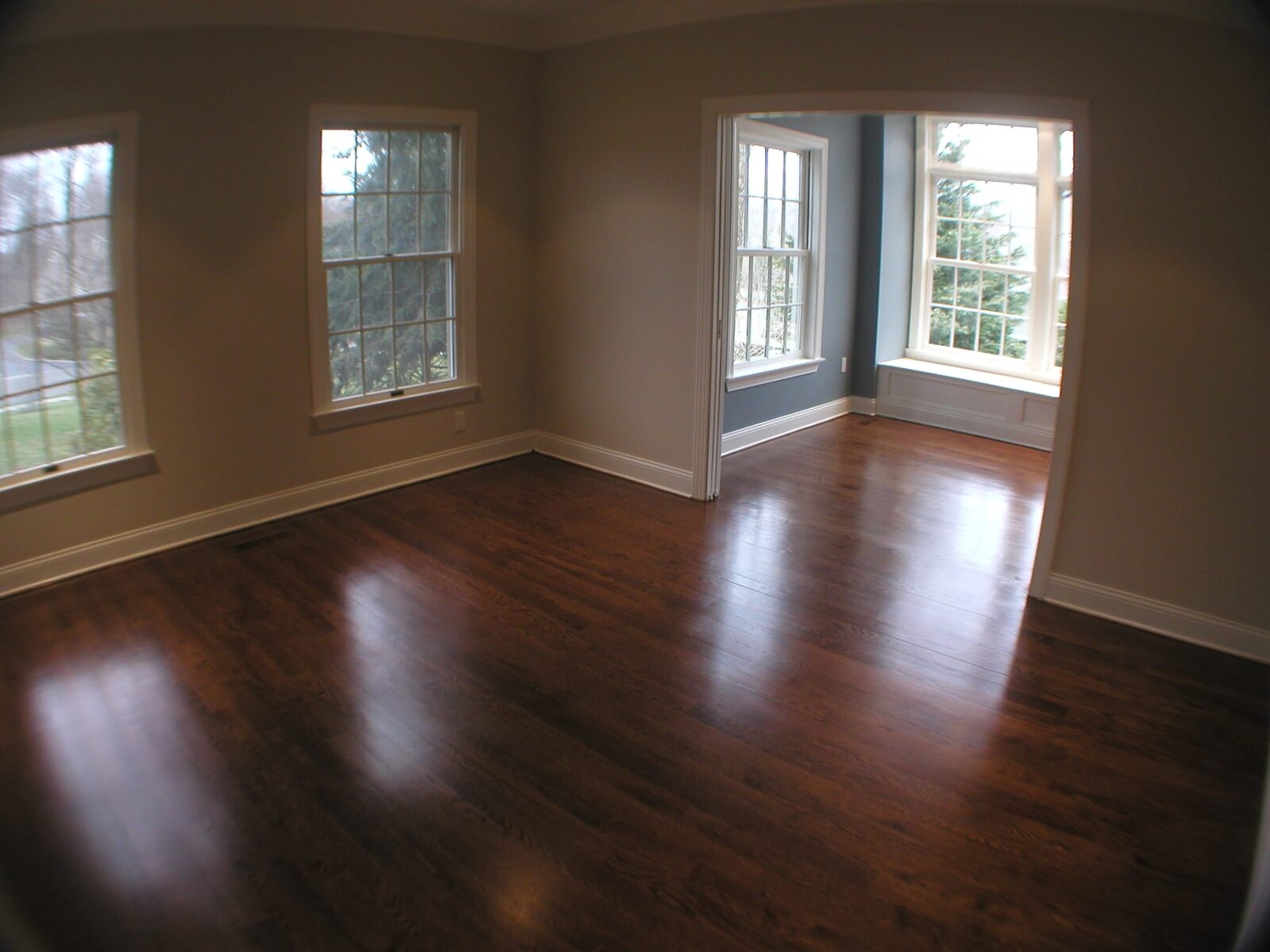 Freshly refinished hardwood floor with a high-gloss sheen by ARK Renovation