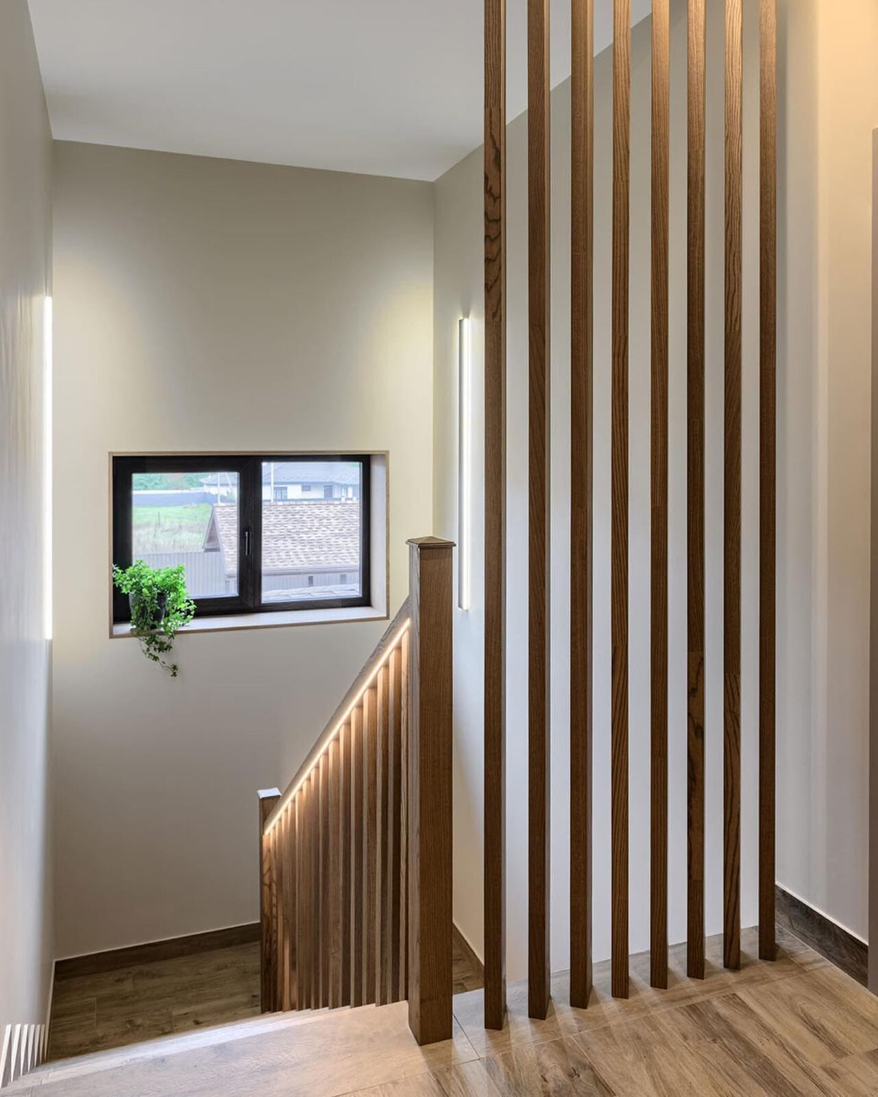 Modern slat-style staircase railing built by ARK Renovation