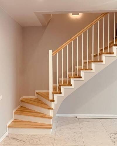 Classic white spindle staircase refinished by ARK Renovation